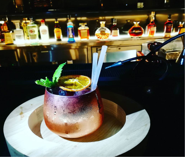 Cocktail in a copper mug with mint and orange
